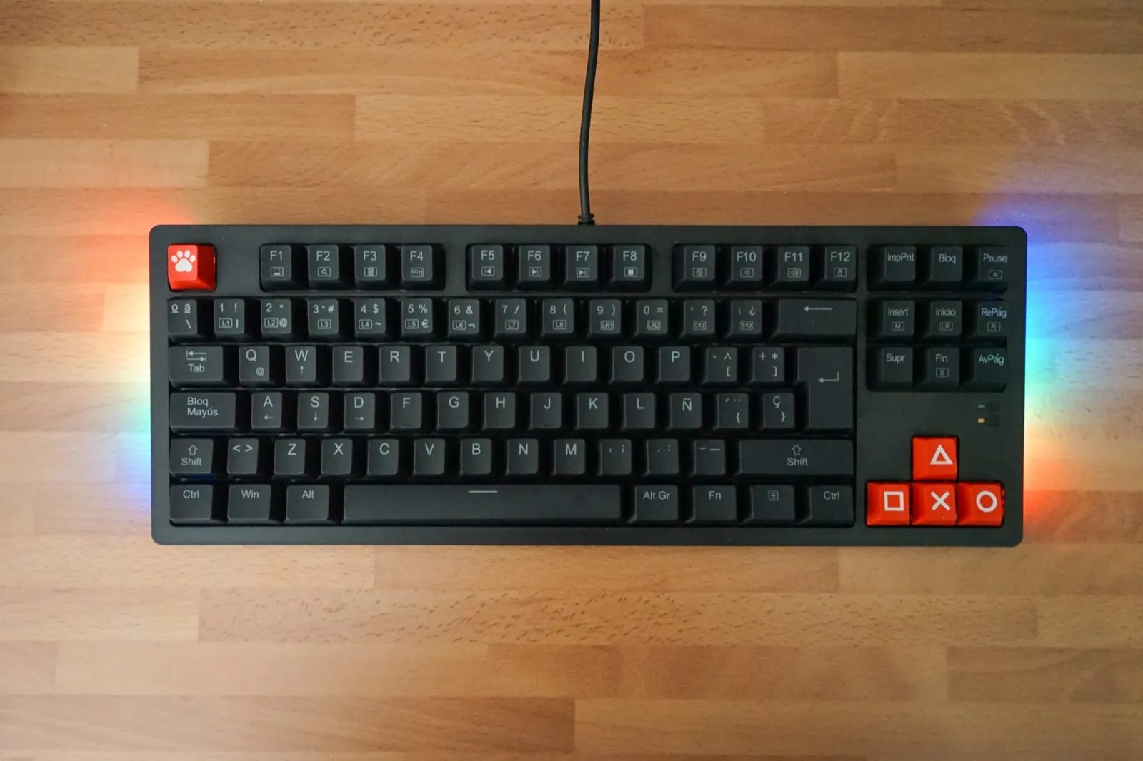 Gaming keyboard with RGB lighting on a wooden desk
