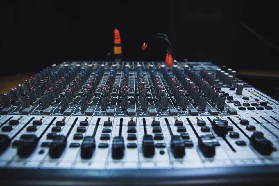 Faders and knobs on an audio mixing desk