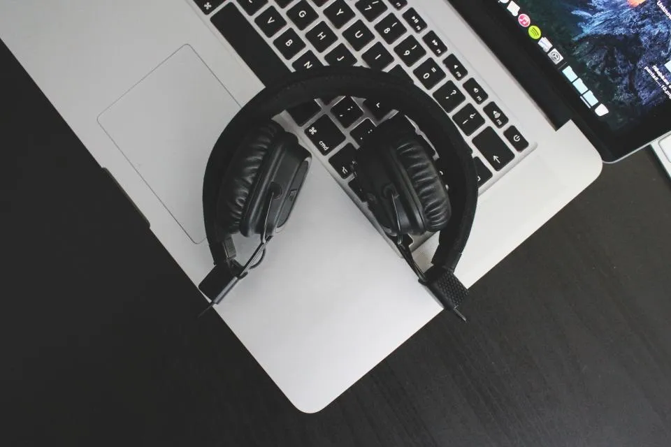 Headphones resting on a laptop keyboard