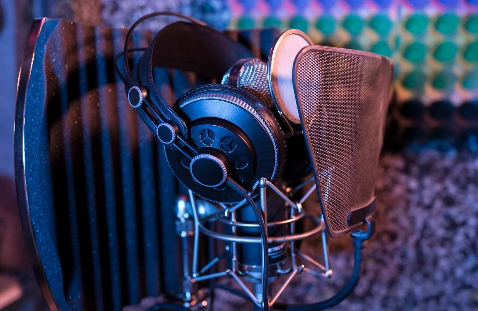 Studio headphones hanging on a microphone stand